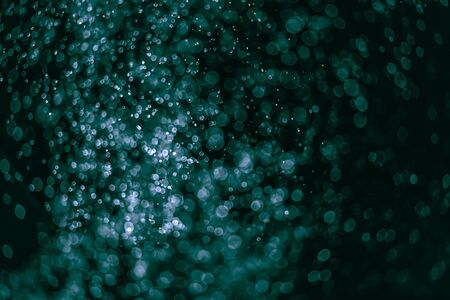 Green fire forms ember abstraction in black backgroundの写真素材