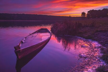 Fishing Boat on a Calm river at Sunriseの写真素材