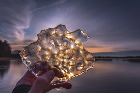 The piece of ice in the hand