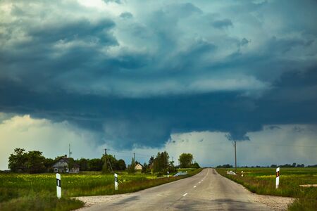 Severe supercell storm clouds with wall cloud and intense rainの写真素材