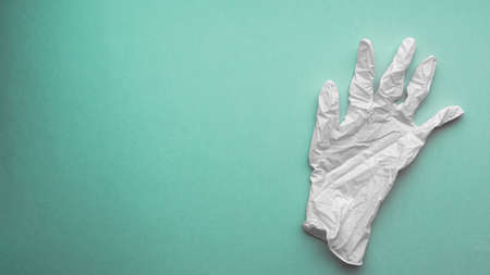 White medical glove on green electric backgroundの写真素材