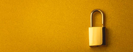 Golden lock on a golden background with empty space for text