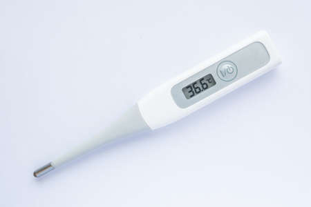 Electronic body thermometer displaying healthy human body temperature 36.6 grades C