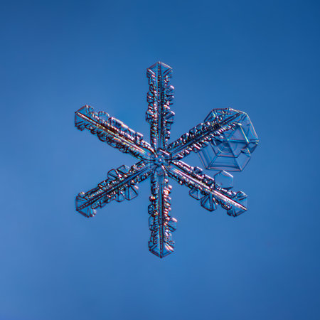 Snowflake on smooth gradient background. Macro photo of real snow crystal on glass surface. This is...
