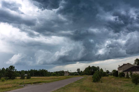 The storm is approaching. A gray sky above trees. Amazing views of clouds. Clouds backgroundの写真素材