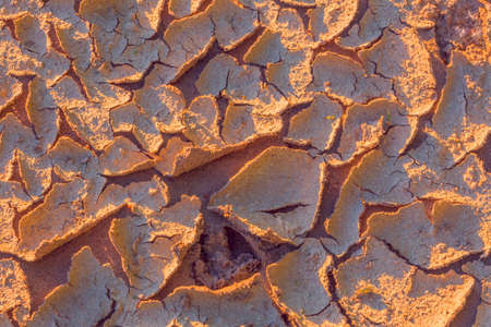 Warm dry cracked land, climate change concept with extreme heatの写真素材
