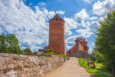 Old Turaida castle with tower in a sunny day. Summer landscape. Gauja national park, Sigulda, Latviaの写真素材