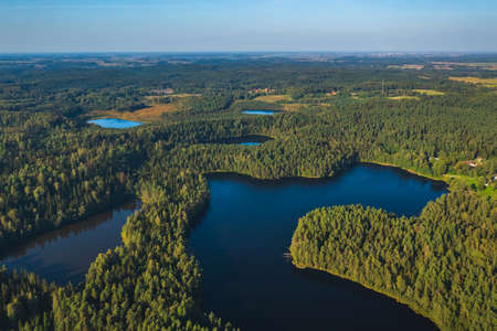 Aerial view of wild forest lake in Lithuaniaの写真素材