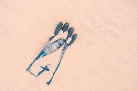 Close Up Of old glove Weathered On Beach Sand Pollution Litter Rubbish In The Baltic seaの写真素材