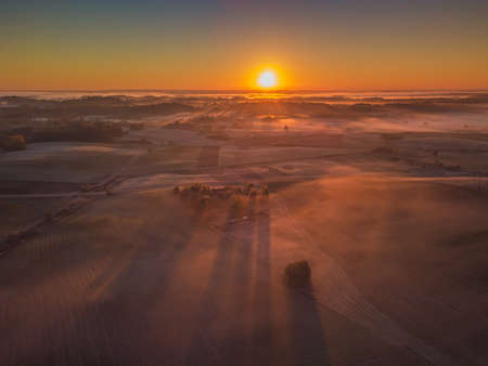 Amazing Sunrise Light Above Misty Landscape. Scenic View Of Foggy Morning In Misty Forest Park Woods. Summer Nature Of Eastern Europe. Sunset Dramatic Sunray Light Sunbeam.の写真素材