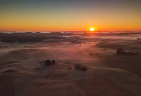 Amazing Sunrise Light Above Misty Landscape. Scenic View Of Foggy Morning In Misty Forest Park Woods. Summer Nature Of Eastern Europe. Sunset Dramatic Sunray Light Sunbeam.の写真素材