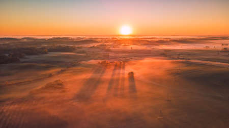 Amazing Sunrise Light Above Misty Landscape. Scenic View Of Foggy Morning In Misty Forest Park Woods. Summer Nature Of Eastern Europe. Sunset Dramatic Sunray Light Sunbeam.の写真素材