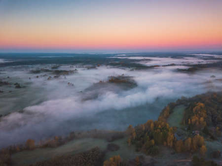 Aerial view of morning fog over the fields at Autumnの写真素材
