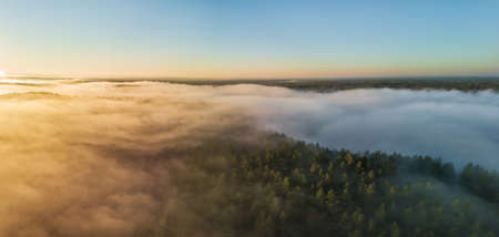 Aerial view of morning fog over the fields at Autumnの写真素材