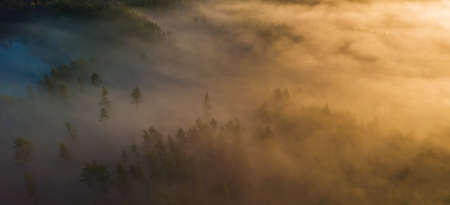 Aerial view of epic light rays over the fields at Autumnの写真素材