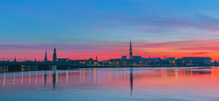 Sunrise over old Riga reflected in the mirror of the Daugavaの写真素材