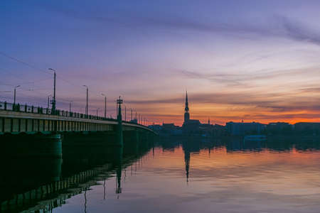 Sunrise over old Riga reflected in the mirror of the Daugavaの写真素材