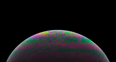 Virtual reality space with abstract multicolor psychedelic planet. Closeup Soap bubble like an alien planet on black background.の写真素材