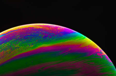 Virtual reality space with abstract multicolor psychedelic planet. Closeup Soap bubble like an alien planet on black background.の写真素材