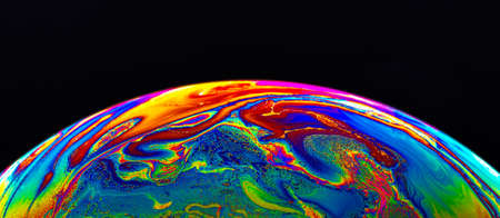 Virtual reality space with abstract multicolor psychedelic planet. Closeup Soap bubble like an alien planet on black background.の写真素材
