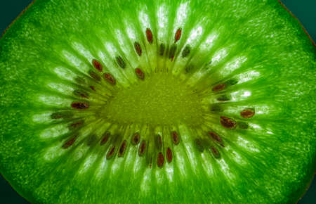 Slice of kiwi fruit close-up on dark background. Horizontal. space for textの写真素材
