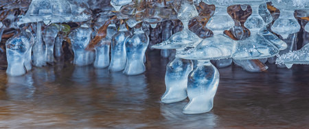 Icicles over the water in the river. Natural landscape. Winter. Background image.の写真素材