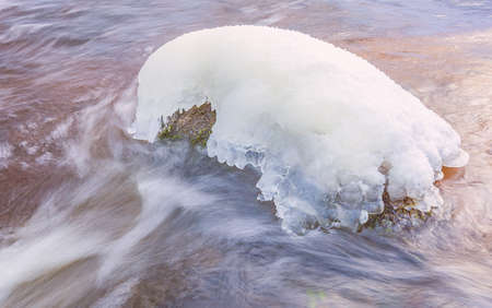 Icicles over the water in the river. Natural landscape. Winter. Background image.の写真素材