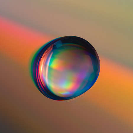 Shiny raibow colored water drops on the old compact CD disc, design for backgroundの写真素材