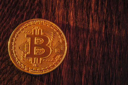 Bitcoin coin on a dark wooden backgroundの写真素材