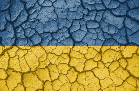 Ukrainian national flag pattern cracked earth, war conceptの写真素材