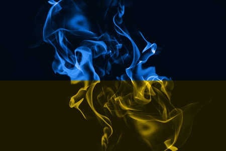 Ukrainian national flag colors with fire, war conceptの写真素材