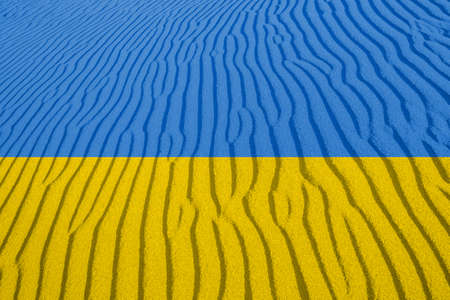 Ukrainian national flag with sand pattern, war conceptの写真素材