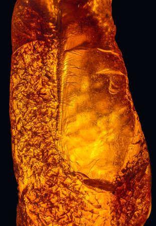 Natural amber texture. Multicolored background for advertising and banners. Vintage fossilized resin as a background. Red amber amber background. Close-up amberの写真素材