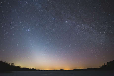 Night landscape image with colorful milky way and zodiac light in the horizonの写真素材