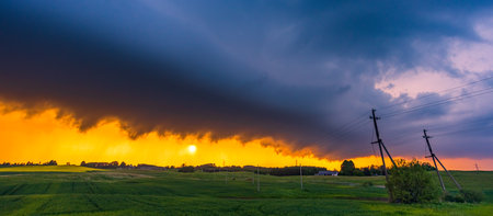Storm cloud in the sunset light, shelf cloud with dramatic lightの写真素材