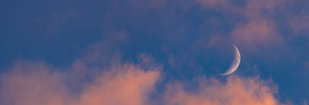 Sunset sky with large crescent moon, evening sky backgroundの写真素材
