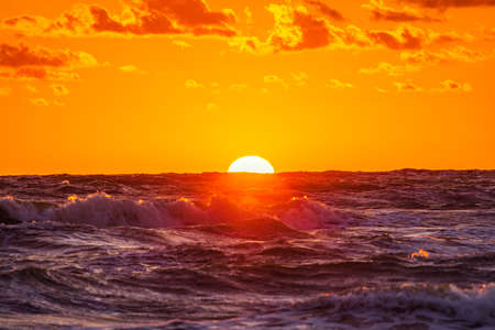 Beautiful summer sunset over beach at Baltic seaの写真素材