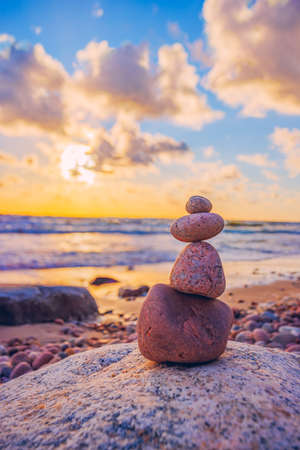 Stone tower on the beach with evening sunset lightの写真素材