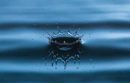 Beautiful splash of water drop. Freeze action. High-speed shooting of water drop. Beautiful drops of stop time, water splashing close up. Crystal clear water waves, drops and spraysの写真素材