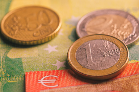 Pile of euro coins on euro notesの写真素材