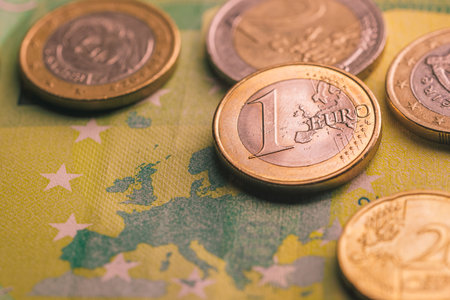 Pile of euro coins on euro notes