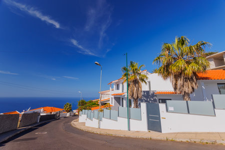 Madeira landscape, settlements built on high cliffs or in the hillsides rising steeply right from the sea shores, Garajau, Madeira island, Portugalの写真素材