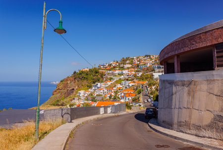 Natural Madeira landscape at the settlements built on high cliffs or in the hillsides rising steeply right from the sea shores, Garajau, Madeira island, Portugalの写真素材