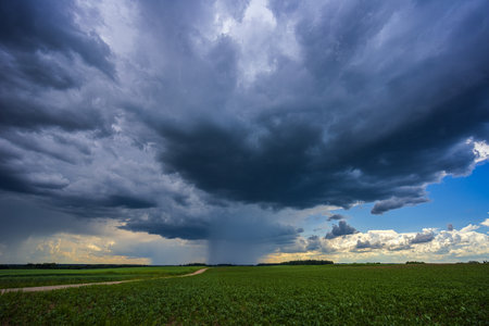 Dramatic storm clouds in blue sky associated with storm, dark, moody weather and looming atmosphere