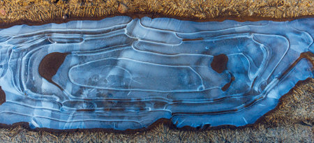 Frozen water on the ground, pattern of iceの写真素材