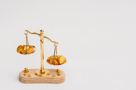 Beautiful Golden Balance Scales with little pieces of gold. Gold cost climbing up. Finance, gold themeの写真素材