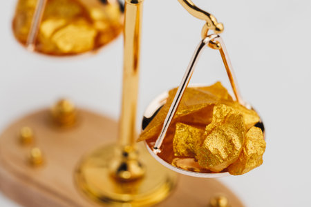 Beautiful Golden Balance Scales with little pieces of gold. Gold cost climbing up. Finance, gold...