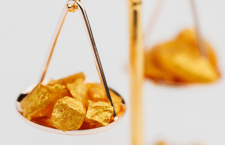 Beautiful Golden Balance Scales with little pieces of gold. Gold cost climbing up. Finance, gold themeの写真素材