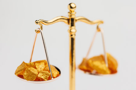 Beautiful Golden Balance Scales with little pieces of gold. Gold cost climbing up. Finance, gold themeの写真素材