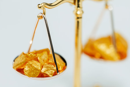 Beautiful Golden Balance Scales with little pieces of gold. Gold cost climbing up. Finance, gold themeの写真素材
